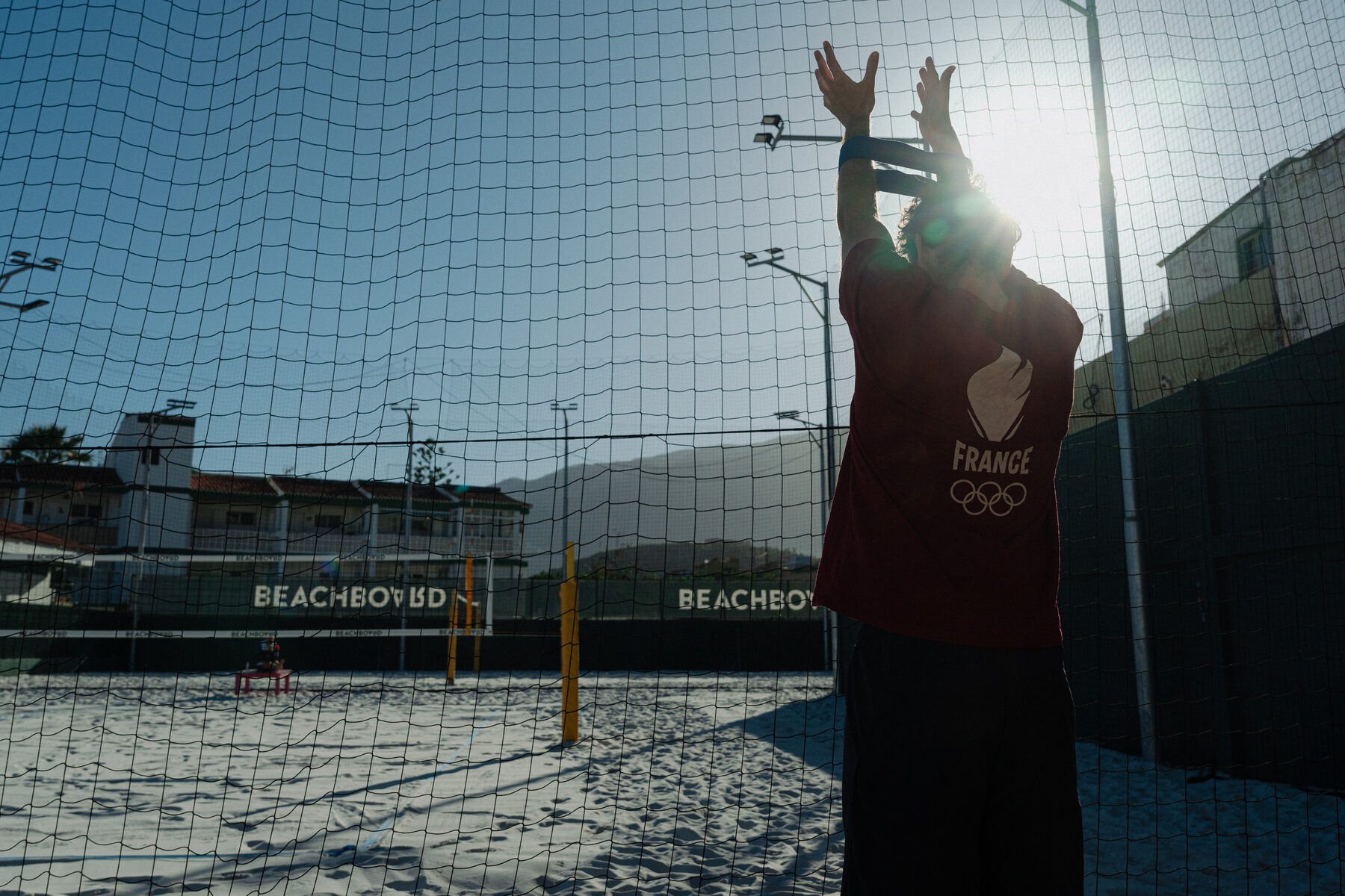 Player warming up at the net in the morning sun