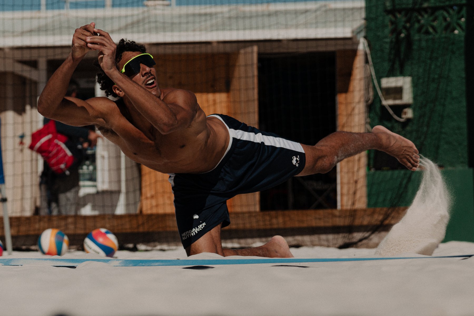 Player diving for the ball at the net
