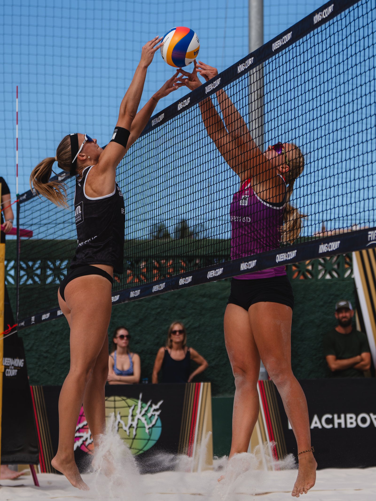 Two players contest a set at the net during a Queen and King of the Court match