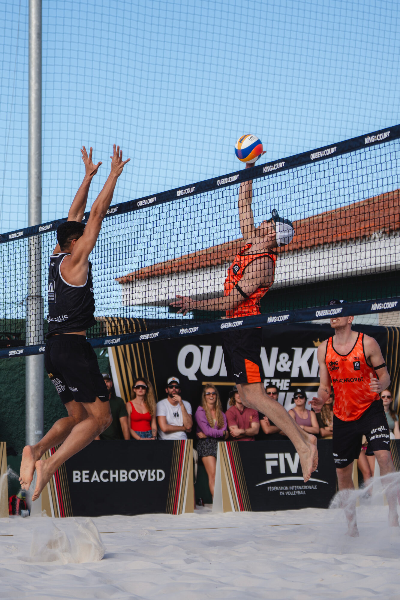 Professional players in a Queen & King of the Court match at the Hacienda, FIVB and Beachboard branding pitch-side