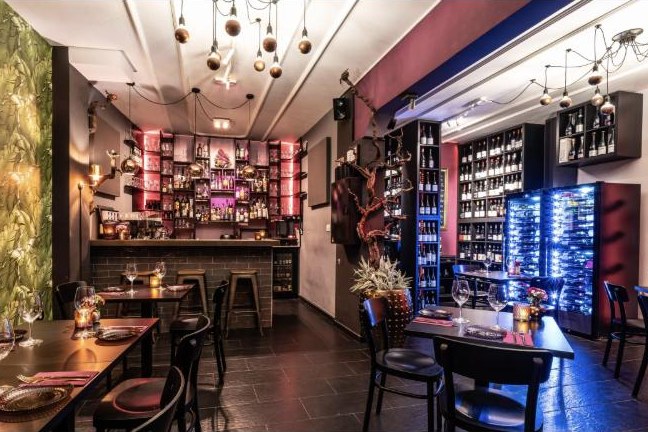 Wine shelves and tables at Vinoteca Con Pasión
