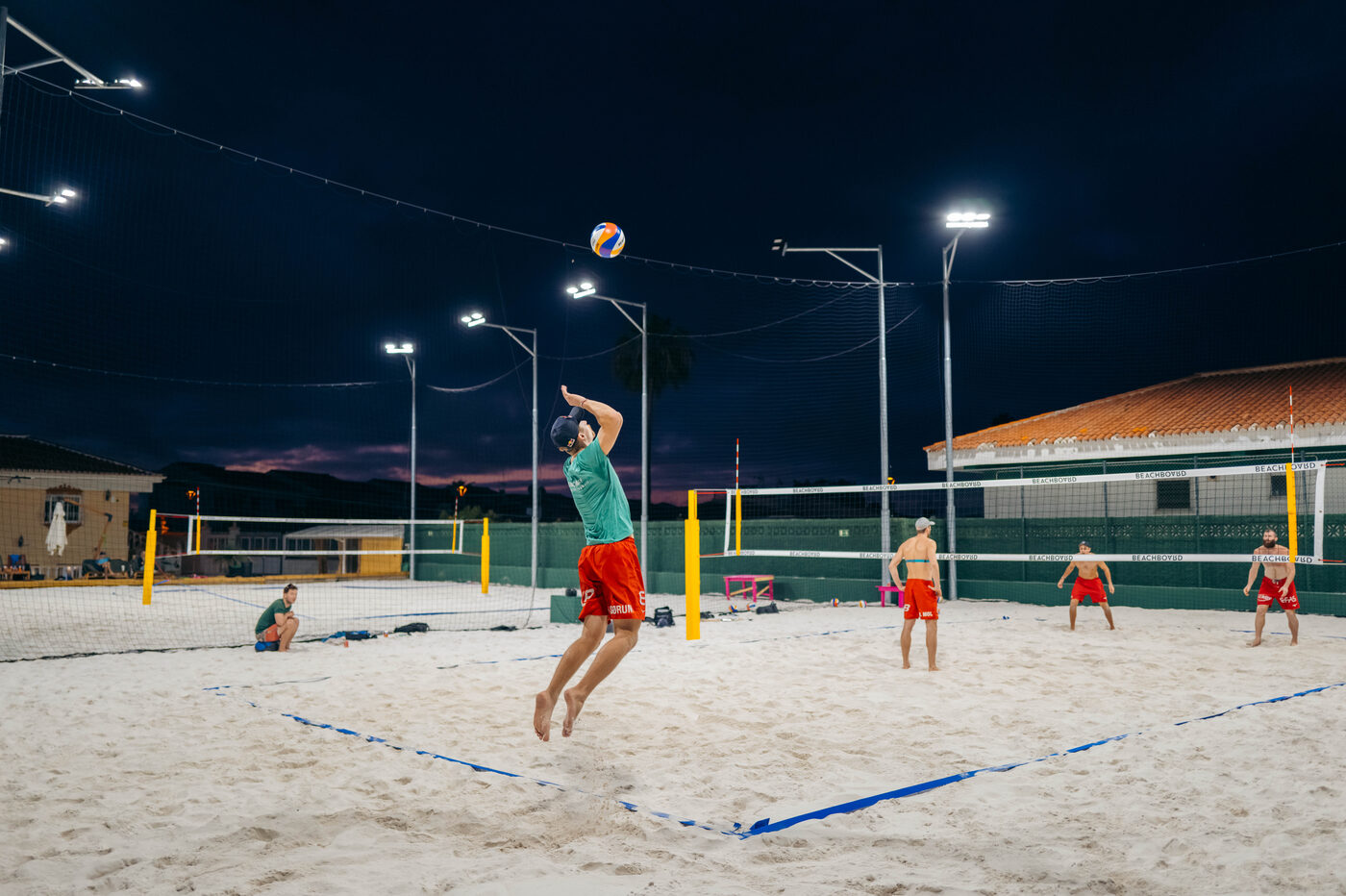 Floodlit sand courts in the evening